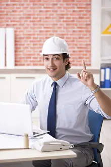 One Person Construction Work Drucke: Construction supervisor working on blueprints