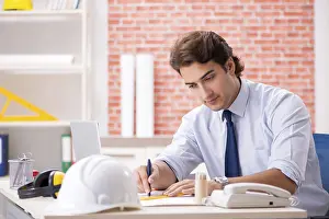 One Person Construction Work Drucke: Construction supervisor working on blueprints
