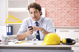 One Person Construction Work Drucke: Construction supervisor working on blueprints