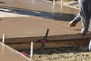 Construction Industry Jobs Drucke: Construction worker snapping line into wet deck cement