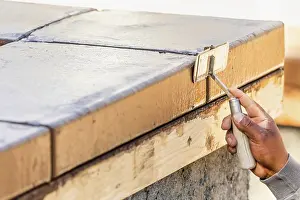Swimming Pool Building Drucke: Construction Worker Using Hand Groover On Wet Cement Forming Coping Around New Pool
