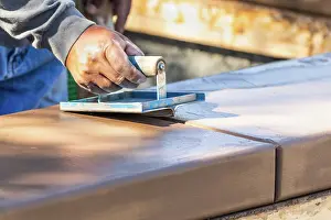 Industrial Building Site Drucke: Construction Worker Using Hand Groover On Wet Cement Forming Coping Around New Pool