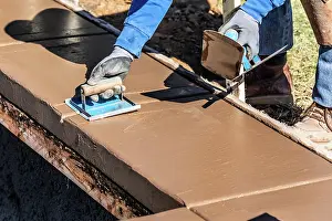 Industrial Building Construction Drucke: Construction Worker Using Hand Groover On Wet Cement Forming Coping Around New Pool