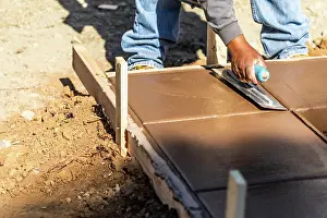 Swimming Pool Coping Installation Drucke: Construction Worker Using Trowel On Wet Cement Forming Coping Around New Pool