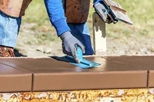 Swimming Pool Construction Drucke: Construction Worker Using Trowel On Wet Cement Forming Coping Around New Pool