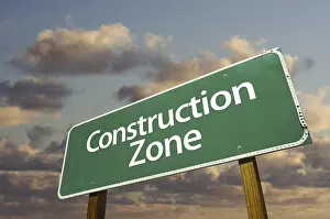 Symbolic Road Sign Image Drucke: Construction zone green road sign in front of dramatic clouds and sky