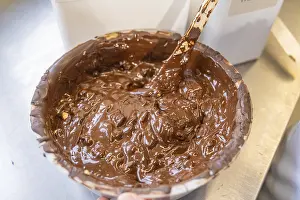European Sweets Manufacturer Drucke: Container with liquid dark chocolate and a spoon