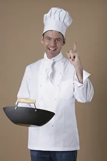 Caucasian Man Cooking Drucke: Cook with pan in the hand
