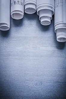 Rolled Up Blueprints Drucke: Copyspace image five blueprints rolled up on blue board