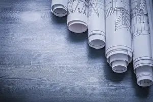 Rolled Blueprints Drucke: Copyspace image rolls of blueprints on blue board