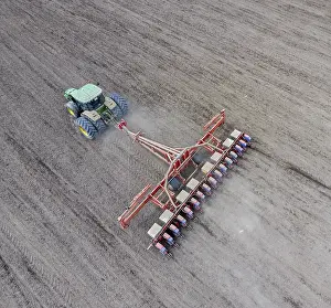 Agricultural Crop Planting Drucke: Corn seeder. Sowing on the field with a seeder of corn