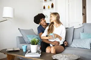 Modern Home Decor Ideas Drucke: A couple sits together on a comfortable couch