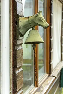 Western Europe Countryside Drucke: A cows head with a bell on a door