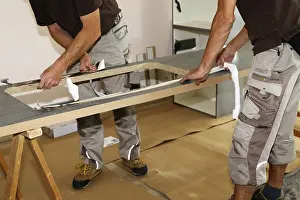 Male Chef In The Kitchen Drucke: Craftsmen installing a new kitchen (kitchen assembly)