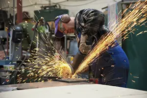Workplace Safety Equipment Drucke: Craftsmen working with an angle grinder in his workshop