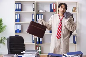 Office Mental Health Crisis Drucke: Crazy young man in straitjacket at the office