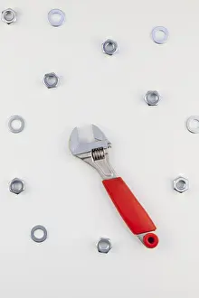 Metal Nuts Drucke: Creative Flat lay of metal nuts and spanner on white background