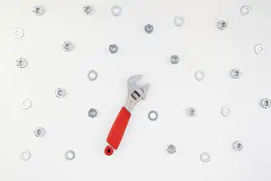 Metal Nuts Drucke: Creative Flat lay of metal nuts and spanner on white background