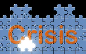 Empty Uninhabited Scene Drucke: Crisis text written on a puzzle background with missing piece