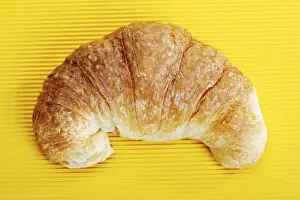 Breakfast Food Drucke: Croissant on a yellow surface
