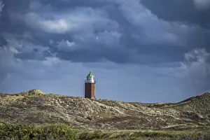 Stormy Atmosphere Germany Drucke: Cross light, lighthouse on sand dune