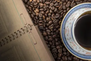 Coffee Background Drucke: Cup of coffee and notebook on coffee background