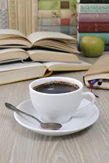 Empty Table Setting Ideas Drucke: A cup of coffee on the table against the background of an open book with a notebook and a stack of books