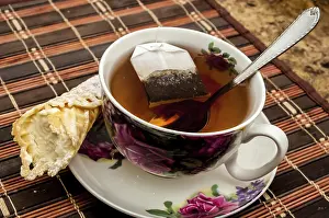 Baked Goods Photography Drucke: Cup of tea with pastry after dinner