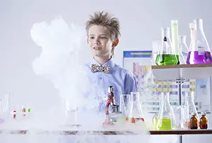 Laboratory Equipment Photos Drucke: Curious pupil posing with test tubes and flasks