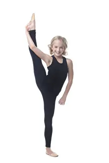 Isolated Female Athlete Drucke: Cute little gymnast posing in vertical split