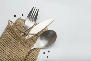 White Table Setting Drucke: Cutlery on white table. Minimal designed fork