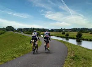 Fitness In Nature Drucke: Cyclist on a cycle path by the river