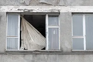 Deserted House In Germany Drucke: A damaged window with a torn blind in a decaying building