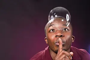 African Ethnicity Studio Photography Drucke: Dark-skinned young man with soap-bubble