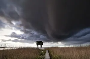 Stormy Atmosphere Photography Drucke: Dark storm cloud over observation tower
