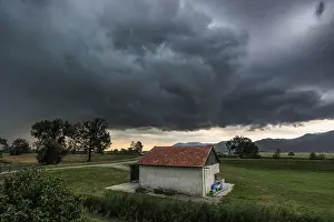 Dark Storm Clouds Drucke: Dark storm clouds over a small barn