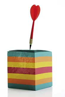 Colourful Office Supply Drucke: Dart stuck in a stack of multicoloured notepaper