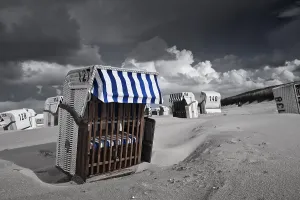 Deserted Beach Chairs Drucke: Beach chairs, dramatic clouds in the sky