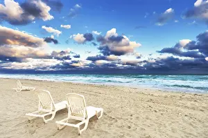 Deserted Beach Chairs Drucke: Deckchairs on a beach on a background of ocean