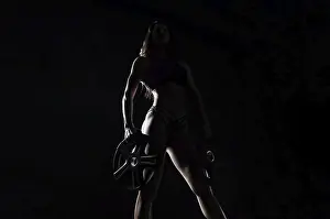 Physical Fitness Model Drucke: Delightful athlete posing in the studio with weights in her hands
