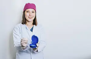 Dental Care Professional Drucke: A dentist with retainers on isolated background