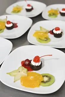 Gastronomy Meal Service Drucke: Dessert on plates in restaurant kitchen ready for serving up