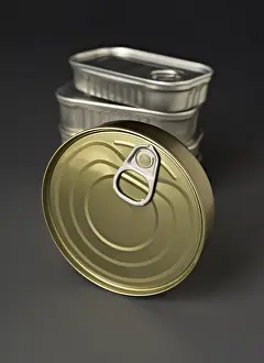 Healthy Eating Habits Concept Drucke: A detailed close up of a stack of cylindrical food cans with convenient pull tab lids