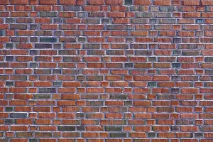 Red Brick Wall Drucke: Detailed view of a brick wall with red and brown bricks forming a regular pattern