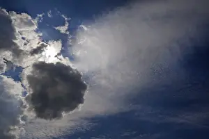 Backlighting In Nature Photography Drucke: Different cloud formations with sun emerging
