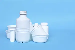 Ecofriendly Packaging Solutions Drucke: Different empty plastic waste packages on blue background with negative space
