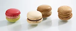 Plain Colored Background Studio Shots Drucke: Four differently coloured macarons in front of a white background