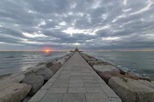 Coastal Protection In Europe Drucke: Dike and lighthouse at Sunrise