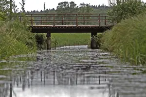 Deserted River Scenery Drucke: Dilapidated bridge over a moat