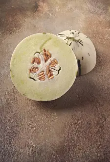 Raw Dessert Ingredients Drucke: Dino melon, cut, on the table, top view